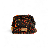 Clutch artesanal negro confetti The Labbo, tejido a mano en España, diseño de lujo sostenible con cadena extraíble.