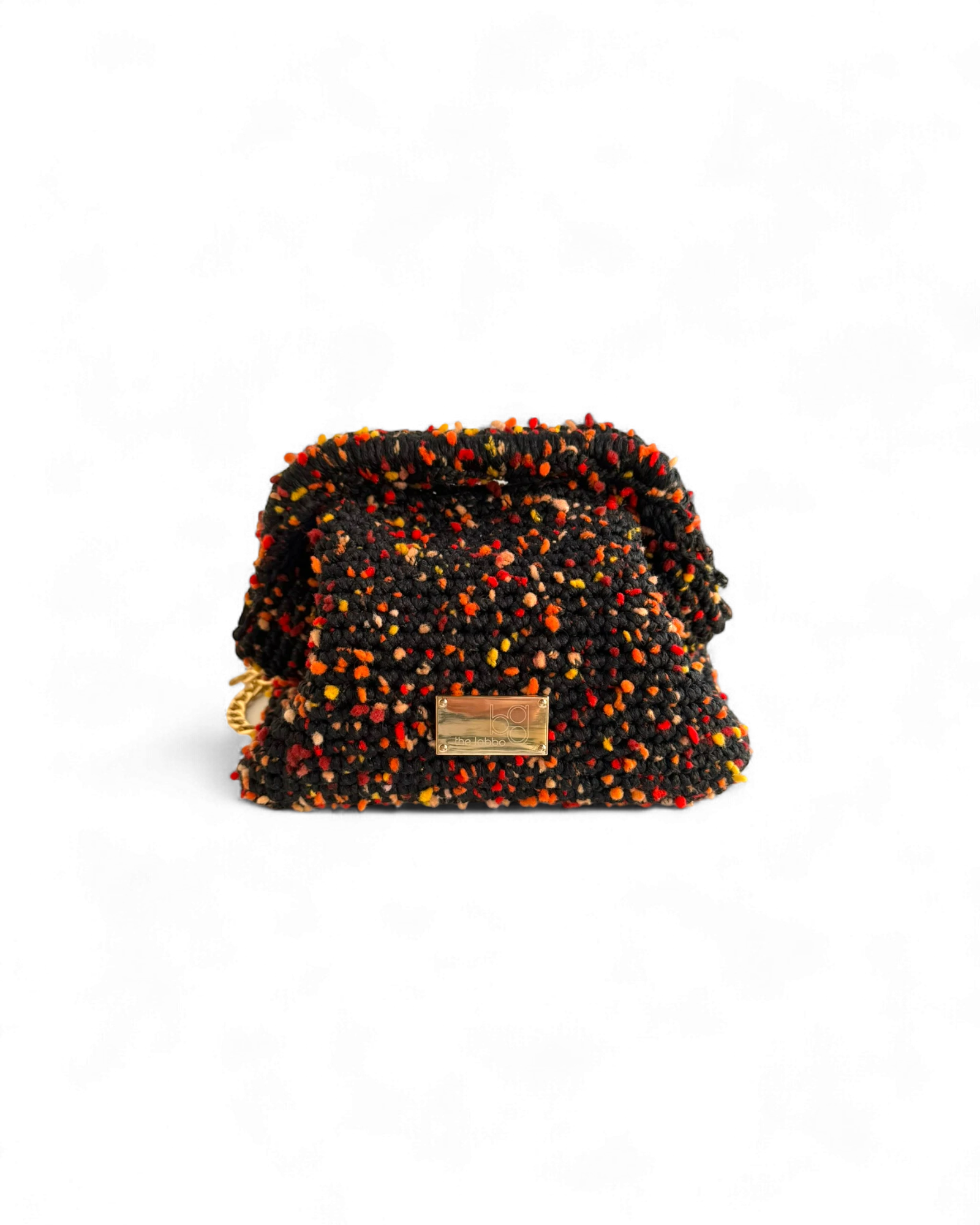 Clutch artesanal negro confetti The Labbo, tejido a mano en España, diseño de lujo sostenible con cadena extraíble.