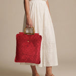 Tote Lace rojo llevado en la mano mostrando proporciones