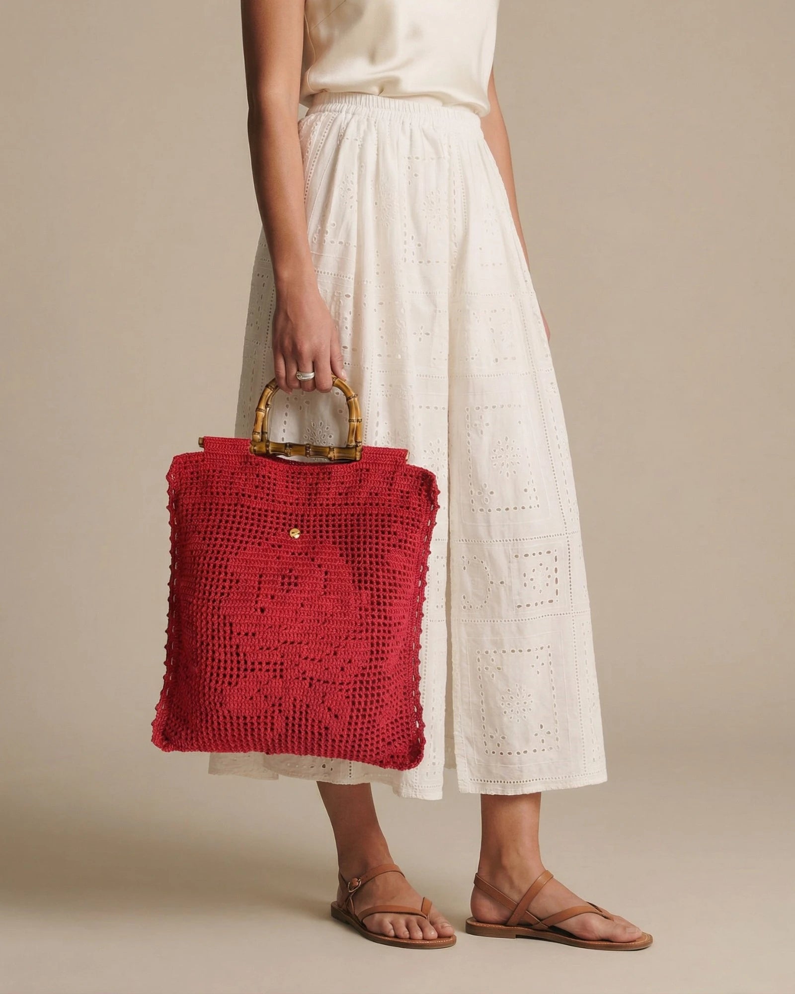 Tote Lace rojo llevado en la mano mostrando proporciones