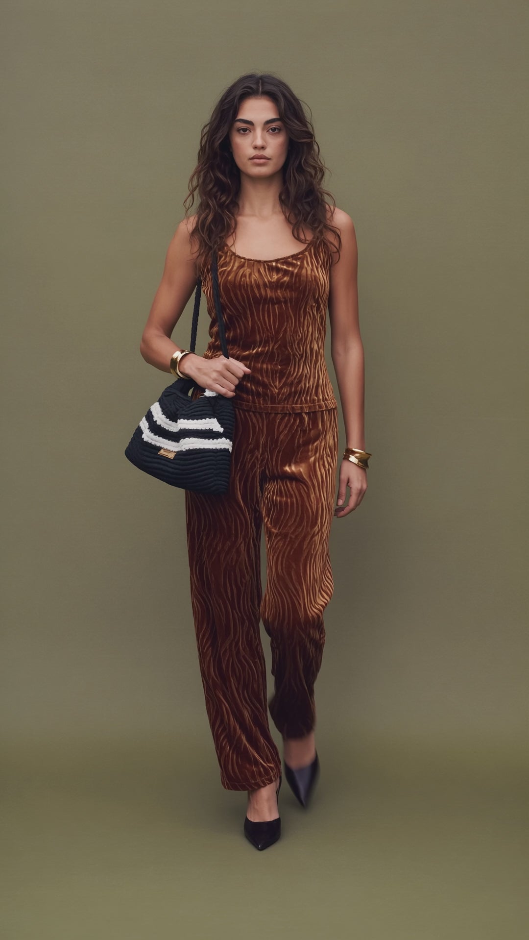Fashion model walks forward, then stops sharply and holds the pose